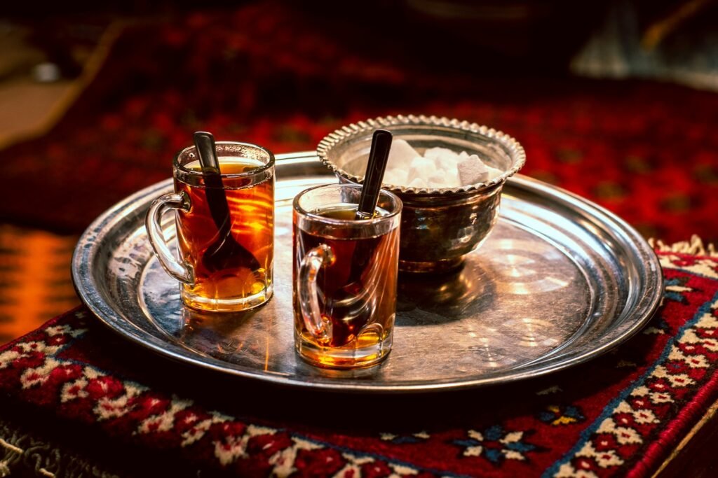 full clear glass teacups on gray tray
